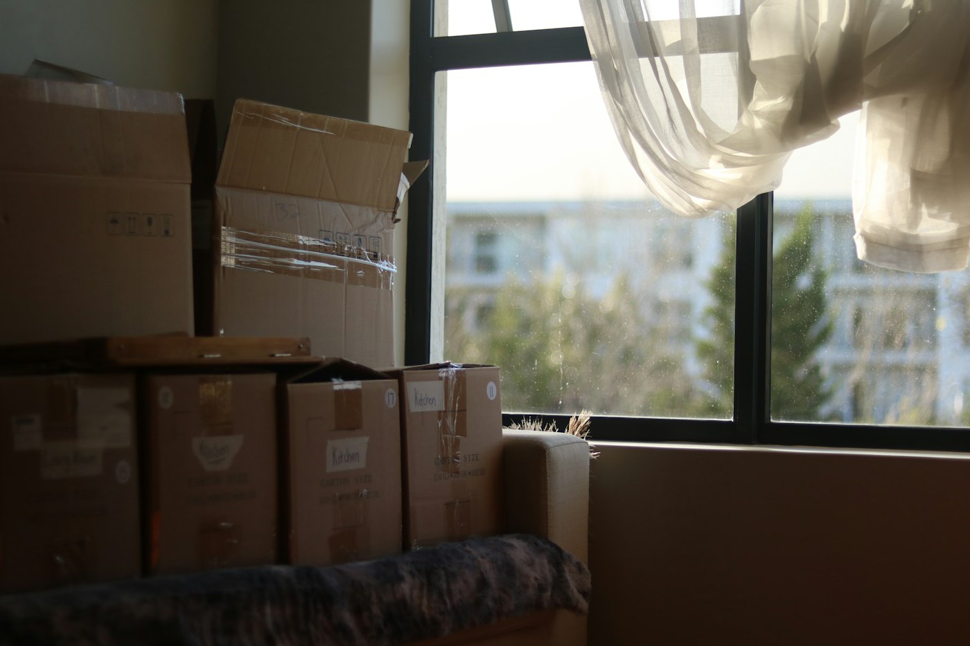 Moving boxes stacked by a window